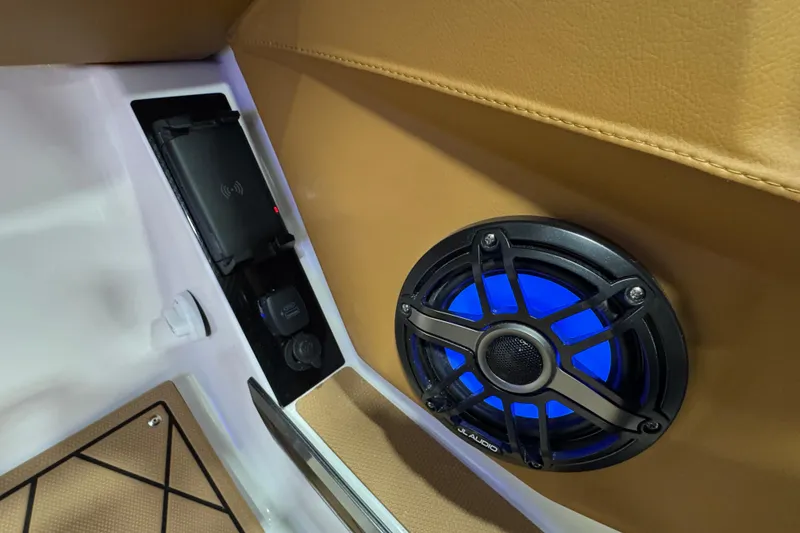 Slide: The Image of 2026 Chaparral 6 SSX interior with illuminated JL Audio speaker and charging station. - 23
