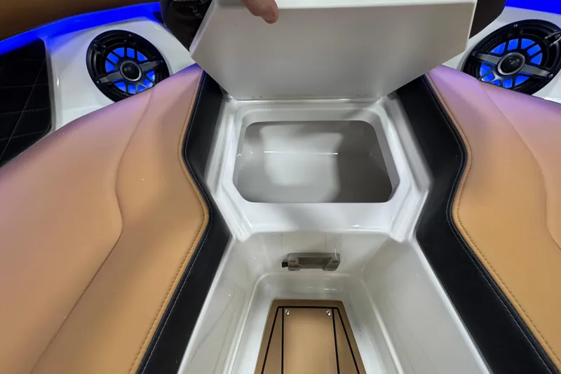Slide: The Image of 2026 Chaparral 6 SSX boat interior with storage compartment and speakers. - 36