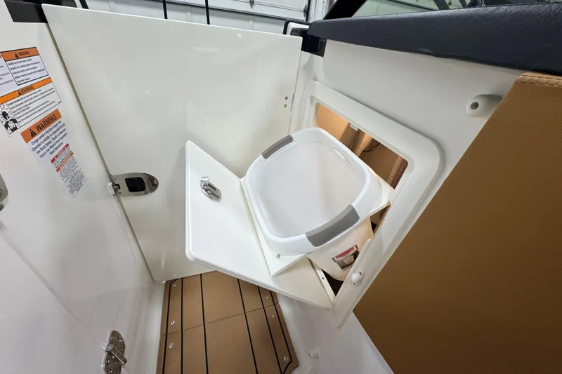 Slide: The Image of 2026 Chaparral 6 SSX boat interior with storage compartment and safety warnings. - 40