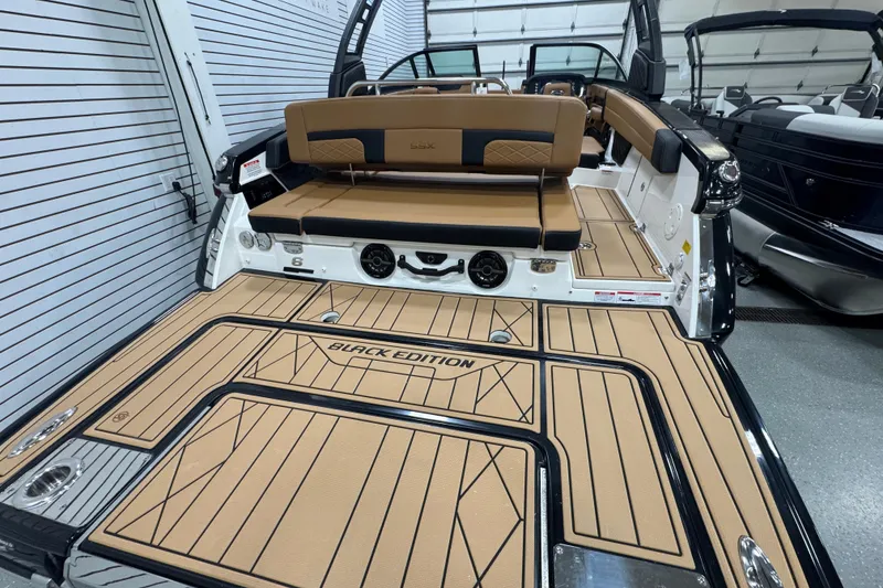 Slide: The Image of 2026 Chaparral 6 SSX Black Edition boat interior with tan and black seating. - 7