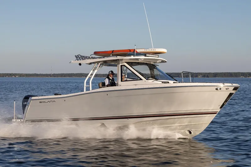Slide: The Image of Manufacturer Provided Image: 2025 Solara S-310 CW boat cruising on a calm lake. - 10