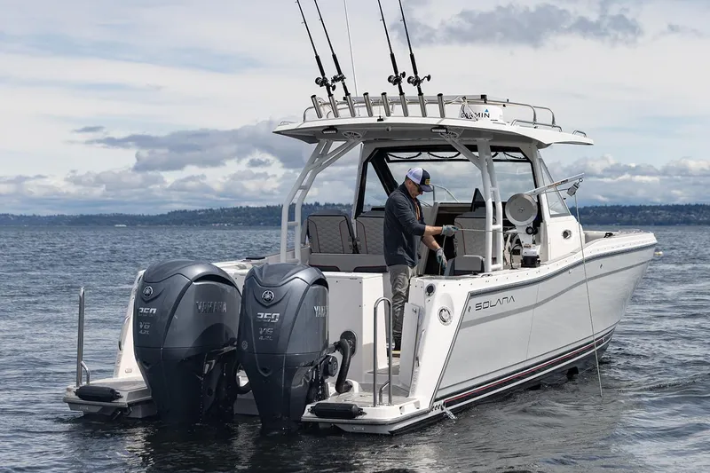 Slide: The Image of Manufacturer Provided Image: 2025 Solara S-310 CW boat with dual engines on a calm sea. - 11