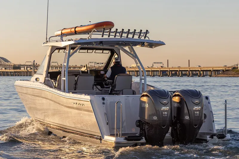 Slide: The Image of Manufacturer Provided Image: 2025 Solara S-310 CW boat with dual engines cruising on water at sunset. - 12