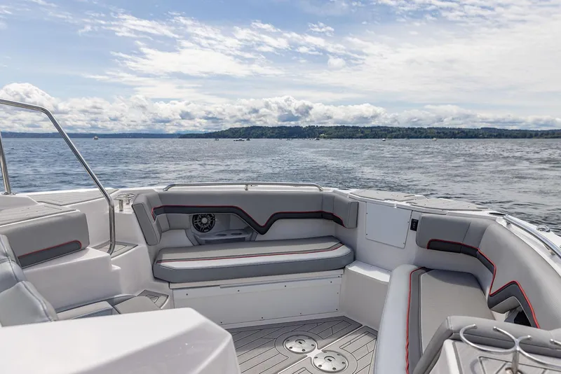 Slide: The Image of Manufacturer Provided Image: Solara S-310 CW 2025 boat interior with seating, on a scenic lake. - 16