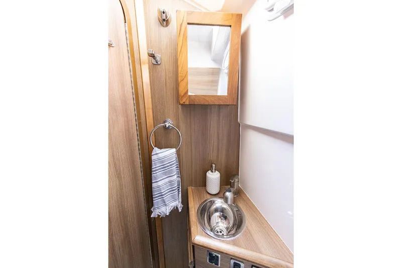 Slide: The Image of Manufacturer Provided Image: Compact bathroom in 2025 Solara S-310 CW with wood accents and stainless steel sink. - 27