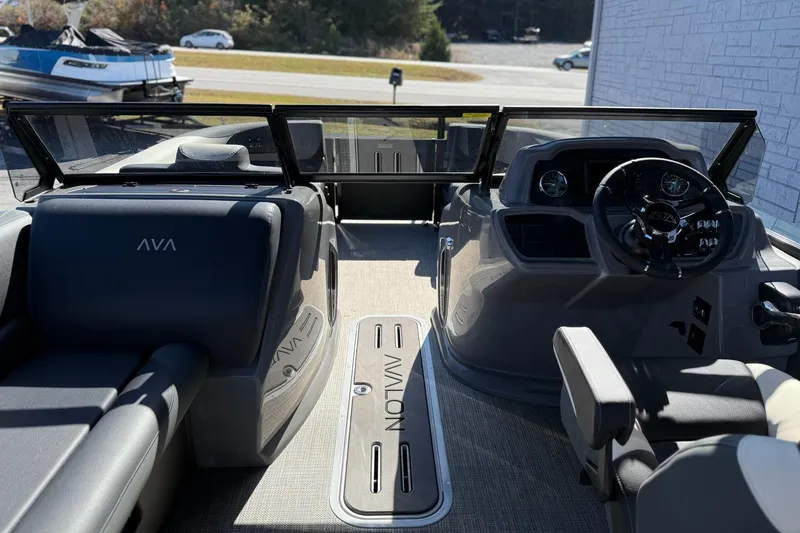 Slide: The Image of 2026 Avalon 2385 LSZ VRB Windshield boat interior with steering wheel and seating. - 10