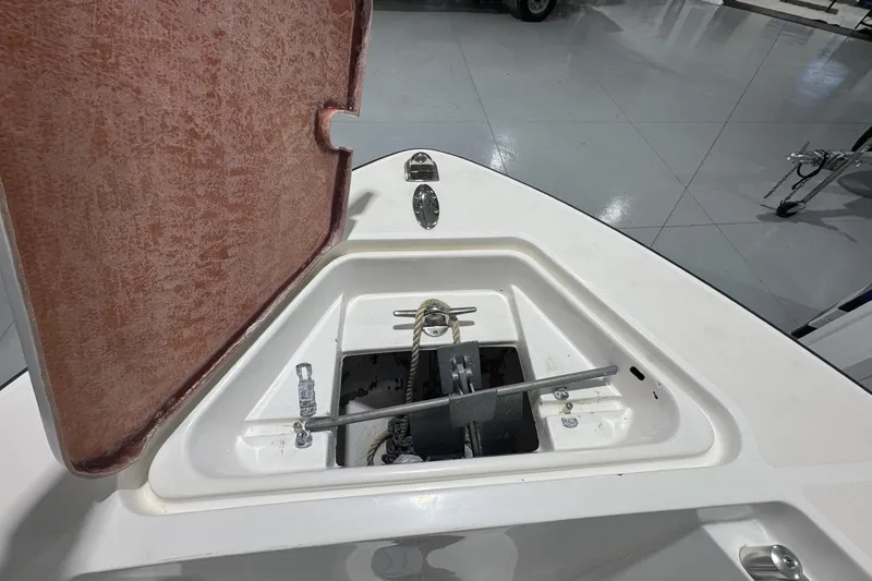 Slide: The Image of Open anchor compartment of 2009 Contender 21 Open boat, showcasing storage and mechanism. - 12