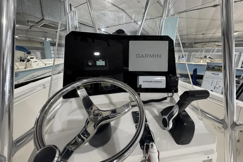 Slide: The Image of 2009 Contender 21 Open boat dashboard with Garmin navigation and steering wheel. - 5
