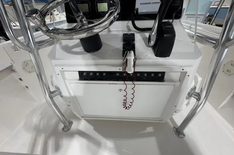 Slide: The Image of 2009 Contender 21 Open boat console with steering wheel and communication devices. - 8
