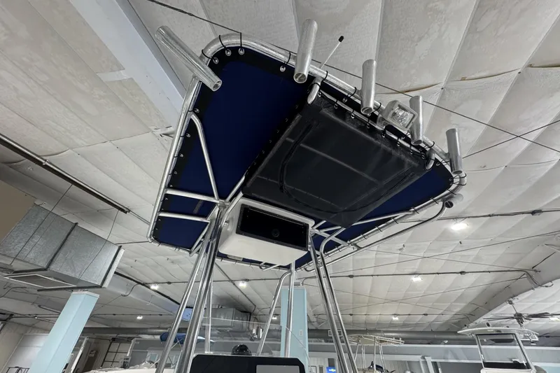 Slide: The Image of 2009 Contender 21 Open boat with T-top and rod holders in a showroom. - 9