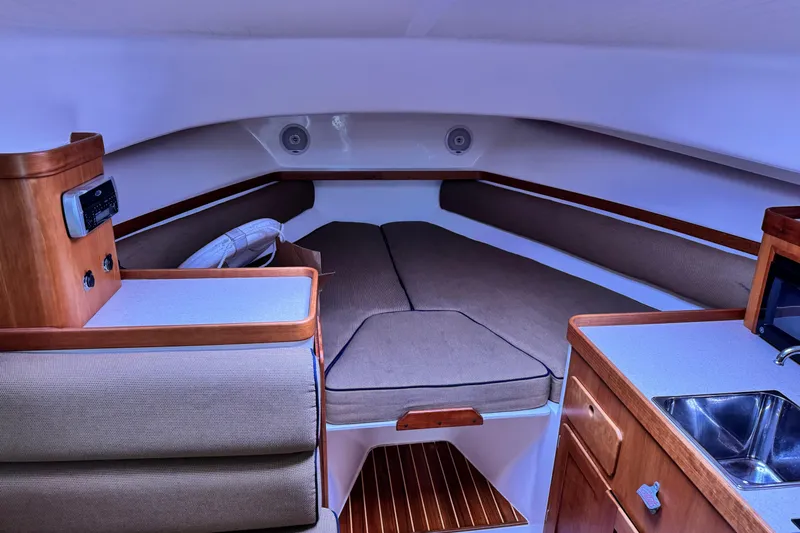 Slide: The Image of Interior of 2005 Hunt SurfHunter boat with cozy cabin and wooden accents. - 5