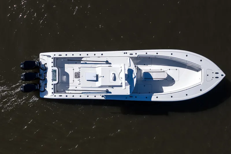 Slide: The Image of 2023 Yellowfin 36 Offshore boat, aerial view, on dark water. - 13
