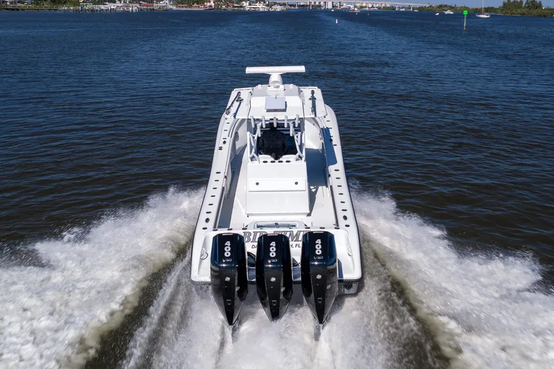 Slide: The Image of 2023 Yellowfin 36 Offshore boat with triple Mercury engines on calm water. - 18