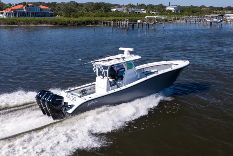 Slide: The Image of 2023 Yellowfin 36 Offshore boat cruising on a scenic waterway. - 20