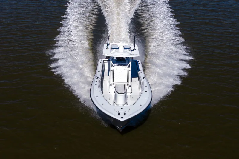 Slide: The Image of 2023 Yellowfin 36 Offshore boat cruising on open water, creating a dynamic wake. - 21