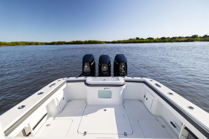 Slide: The Image of 2023 Yellowfin 36 Offshore boat with triple engines on calm water. - 26