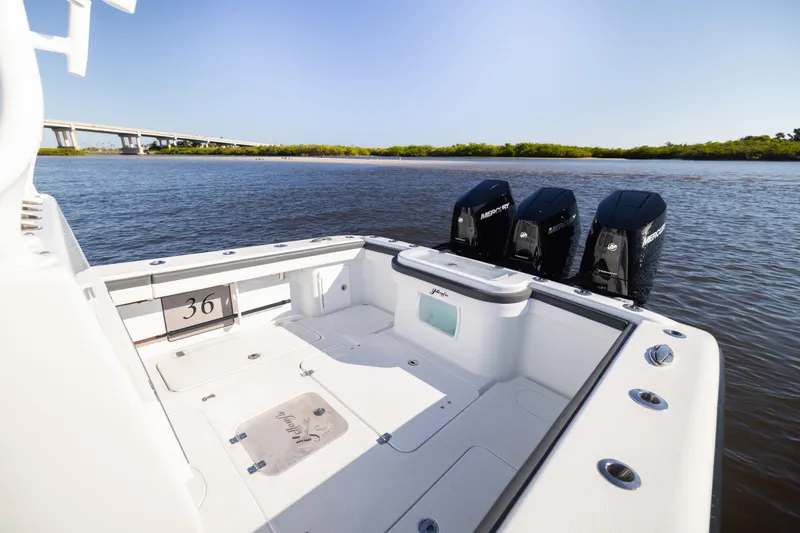 Slide: The Image of 2023 Yellowfin 36 Offshore boat with triple Mercury engines on calm water. - 27