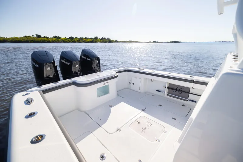 Slide: The Image of 2023 Yellowfin 36 Offshore boat with triple Mercury engines on calm water. - 28