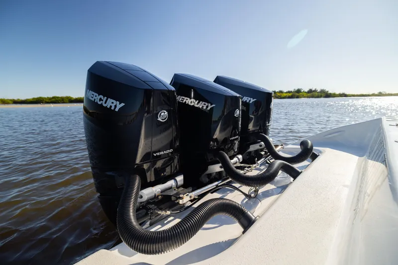 Slide: The Image of Triple Mercury Verado engines on 2023 Yellowfin 36 Offshore boat in sunny waters. - 30