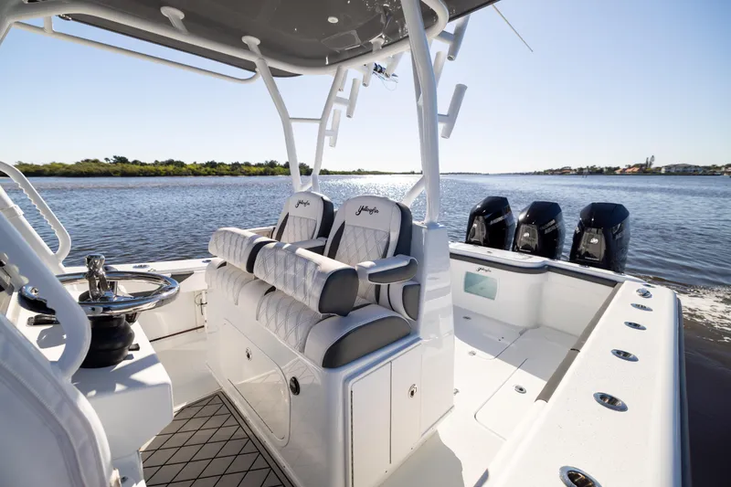 Slide: The Image of 2023 Yellowfin 36 Offshore boat interior with triple engines on a sunny day. - 35