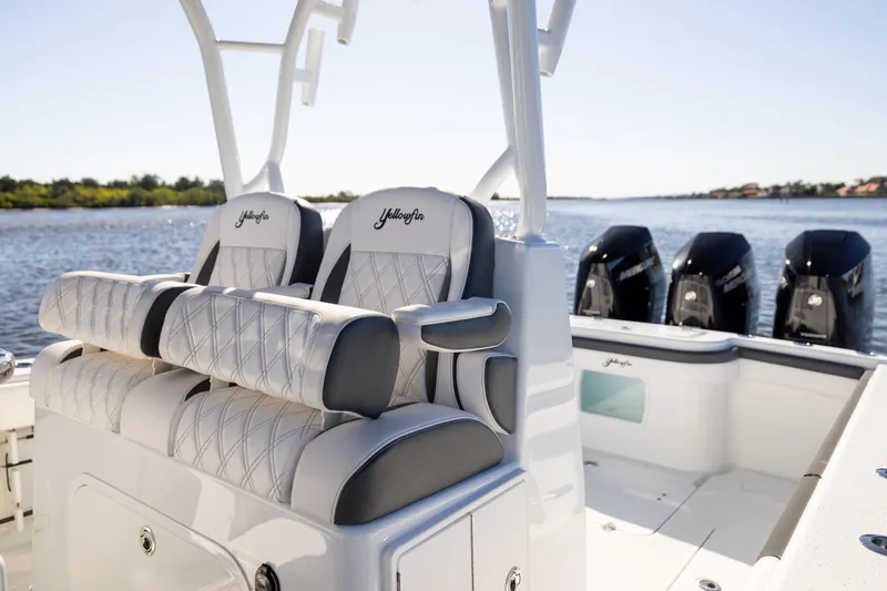 Slide: The Image of 2023 Yellowfin 36 Offshore boat with luxurious seating and powerful engines on a sunny day. - 36