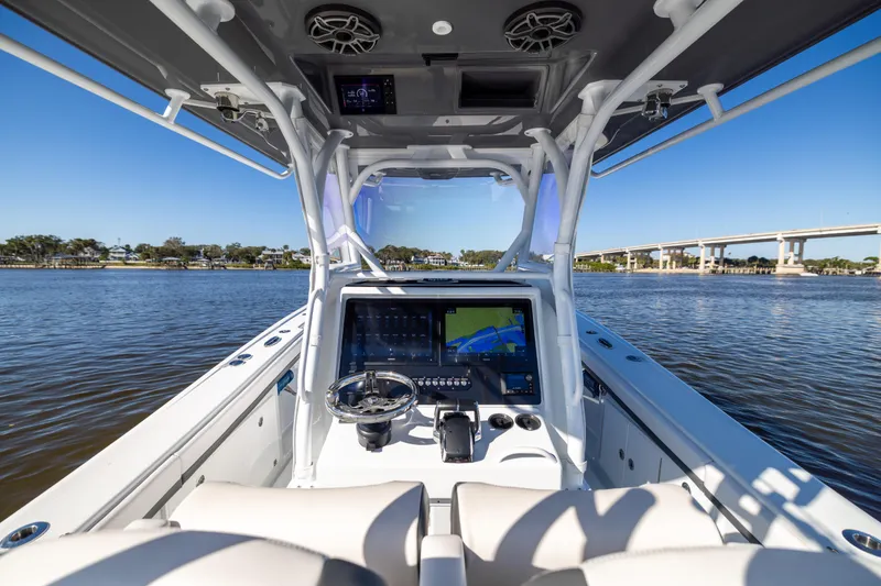 Slide: The Image of 2023 Yellowfin 36 Offshore boat cockpit with advanced navigation system on a sunny day. - 39