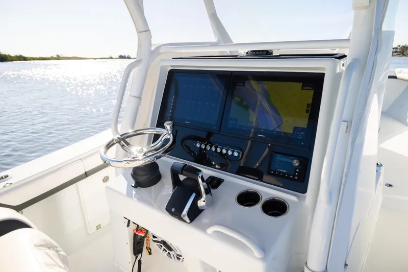 Slide: The Image of 2023 Yellowfin 36 Offshore boat dashboard with navigation screens and steering wheel. - 42