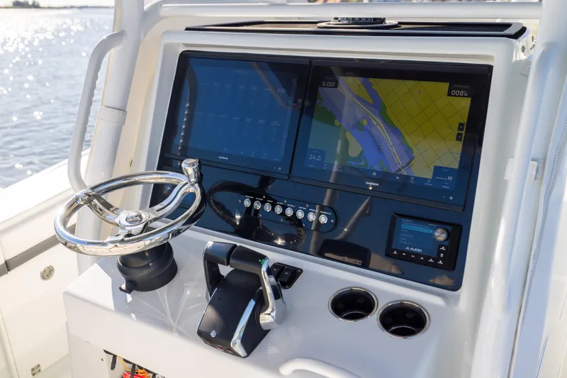 Slide: The Image of 2023 Yellowfin 36 Offshore boat dashboard with navigation screens and steering wheel. - 43