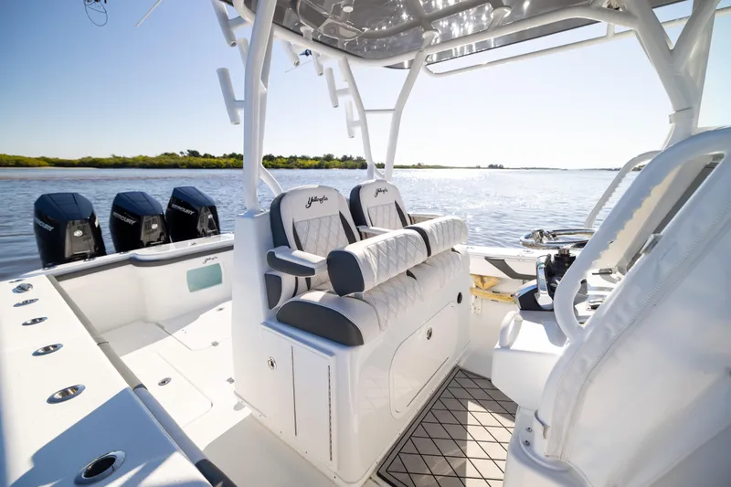 Slide: The Image of 2023 Yellowfin 36 Offshore boat interior with seating and multiple outboard engines. - 44