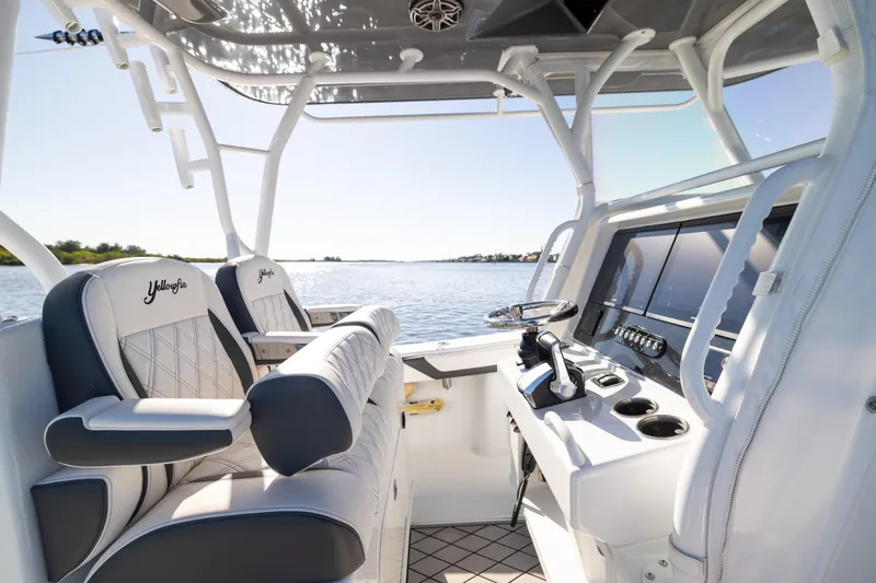 Slide: The Image of 2023 Yellowfin 36 Offshore boat interior with luxury seating and modern controls. - 45