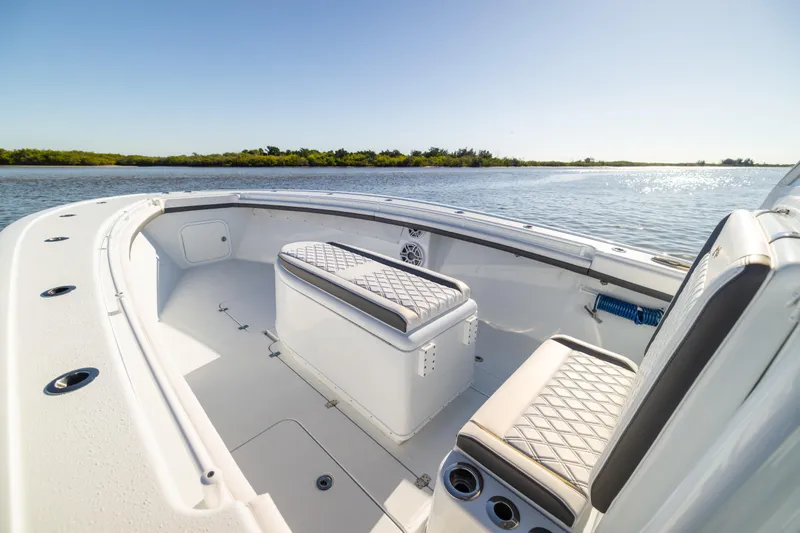 Slide: The Image of 2023 Yellowfin 36 Offshore boat interior with seating, on a sunny day by the water. - 50