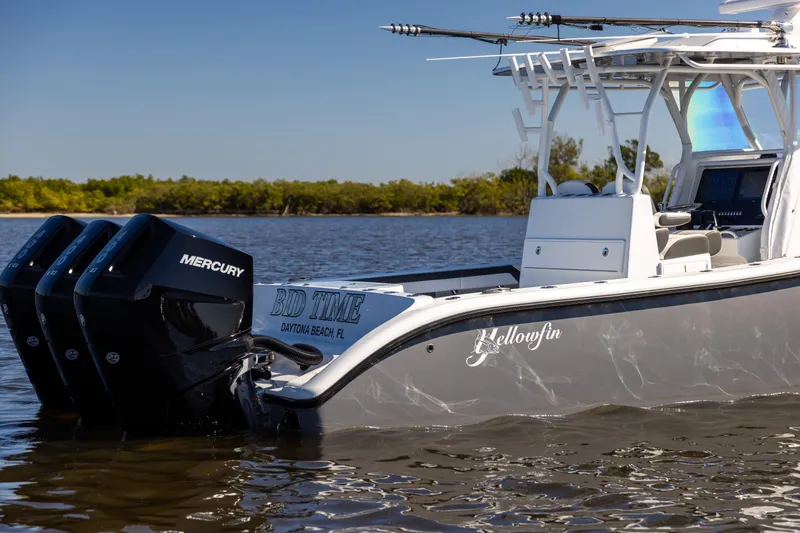 Slide: The Image of 2023 Yellowfin 36 Offshore boat with triple Mercury engines on calm water. - 6