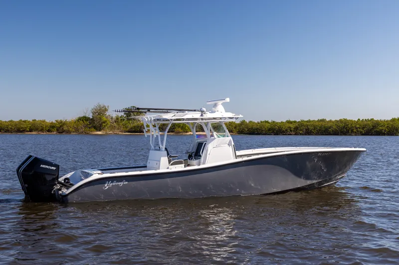Slide: The Image of 2023 Yellowfin 36 Offshore boat on calm water, clear sky background. - 9