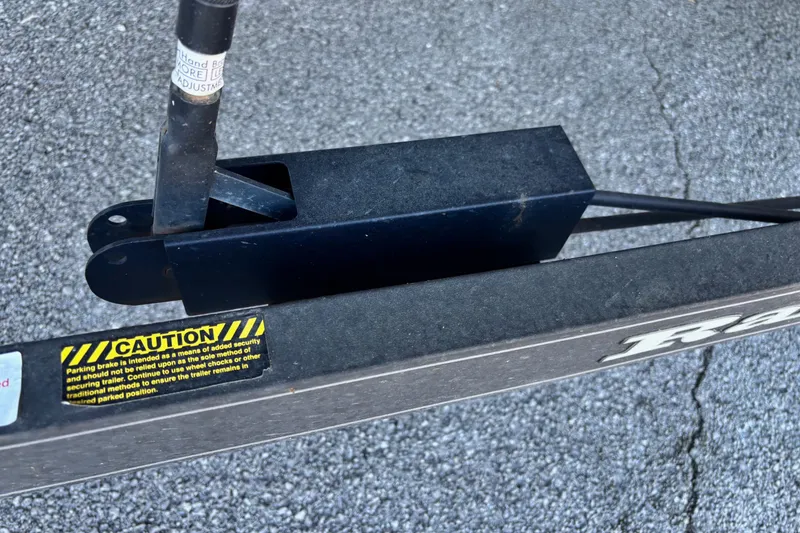 Slide: The Image of 2017 Ranger Z521 Comanche trailer hitch with caution label on asphalt. - 2