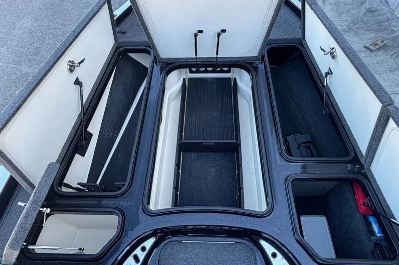 Slide: The Image of 2017 Ranger Z521 Comanche boat storage compartments open, showcasing organized interior layout. - 7
