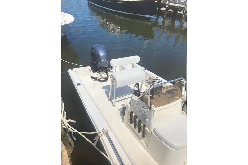Slide: The Image of 2004 Mako 201 Center Console boat docked with outboard motor. - 2