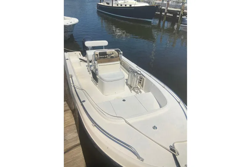 Slide: The Image of 2004 Mako 201 Center Console boat docked in a marina. - 3