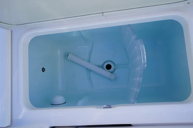 Slide: The Image of 2023 Robalo 266 Cayman boat storage compartment, open and empty. - 15