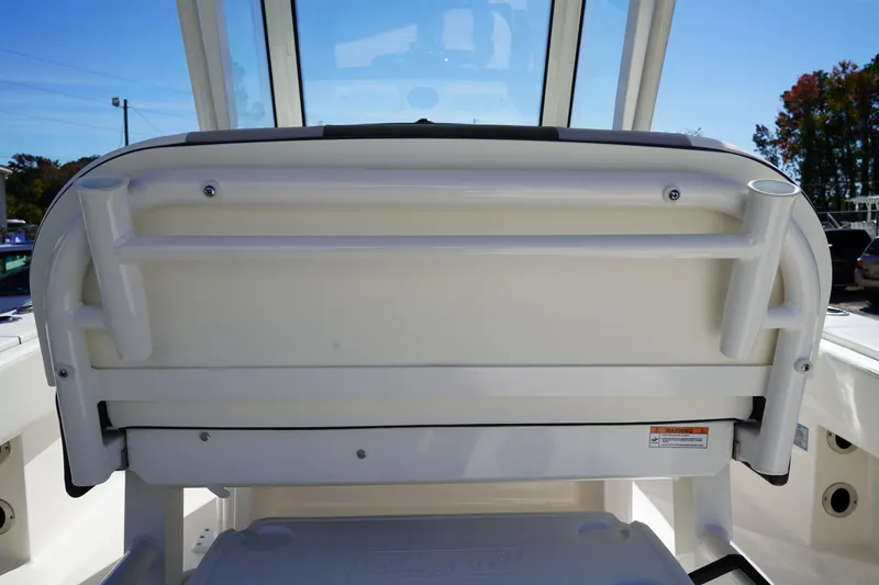 Slide: The Image of 2023 Robalo 266 Cayman boat interior, featuring a sleek white seating area. - 19