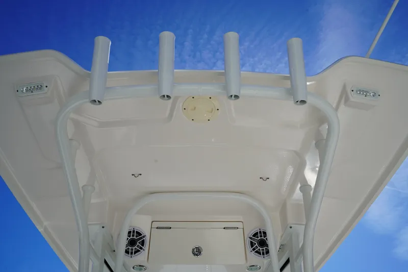 Slide: The Image of 2023 Robalo 266 Cayman boat top view with rod holders against blue sky. - 21