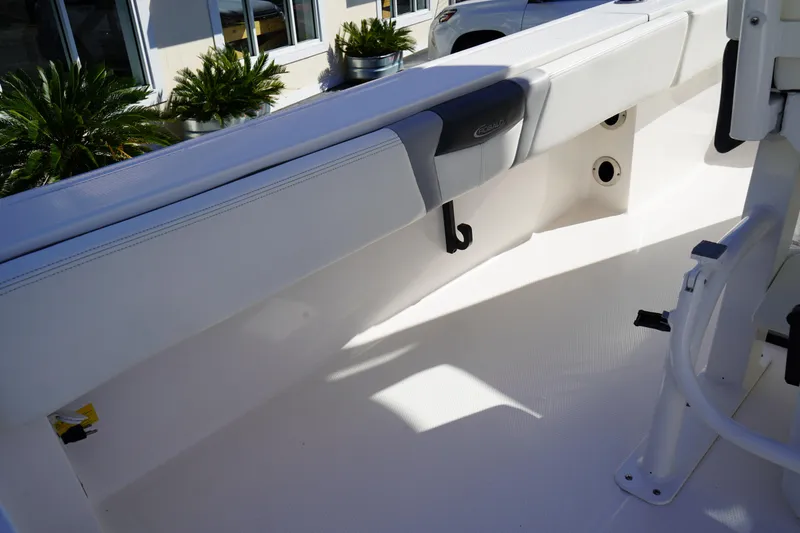 Slide: The Image of 2023 Robalo 266 Cayman boat interior with seating and storage features. - 23
