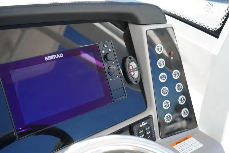 Slide: The Image of Control panel of 2023 Robalo 266 Cayman boat with Simrad display and buttons. - 27