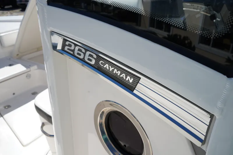 Slide: The Image of 2023 Robalo 266 Cayman boat detail with model nameplate and sleek design. - 29