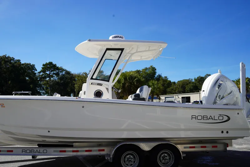 Slide: The Image of 2023 Robalo 266 Cayman boat on trailer, side view, clear sky background. - 3