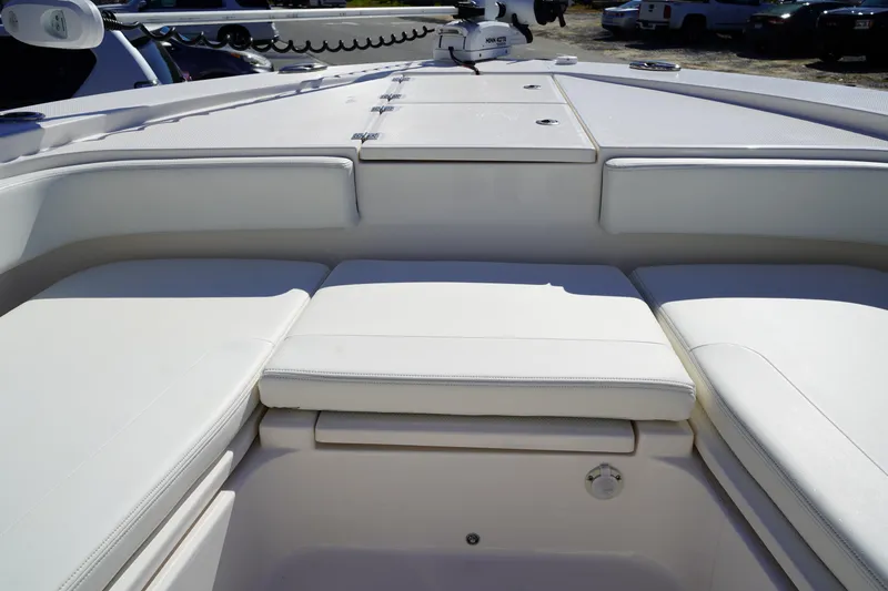 Slide: The Image of 2023 Robalo 266 Cayman boat interior with cushioned seating and storage compartments. - 33