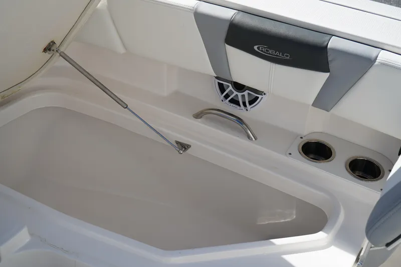 Slide: The Image of 2023 Robalo 266 Cayman boat interior with storage compartment and cup holders. - 34