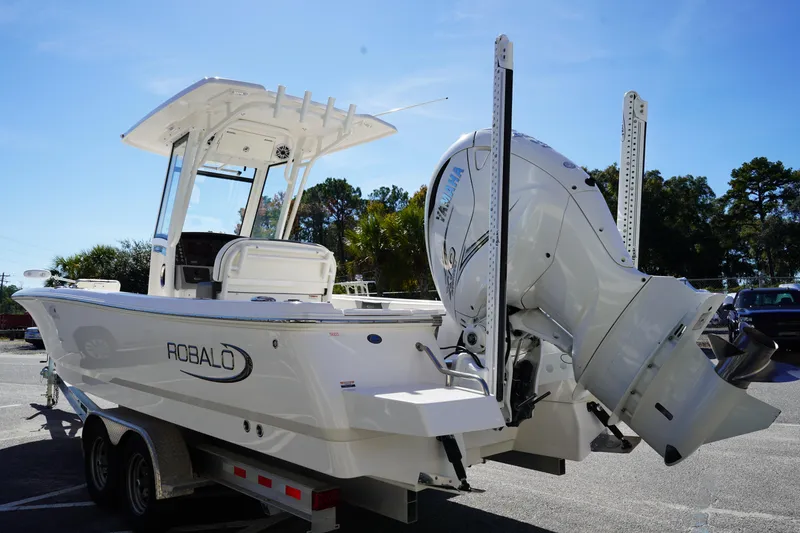 Slide: The Image of 2023 Robalo 266 Cayman boat with Yamaha engine on trailer, outdoor setting. - 5