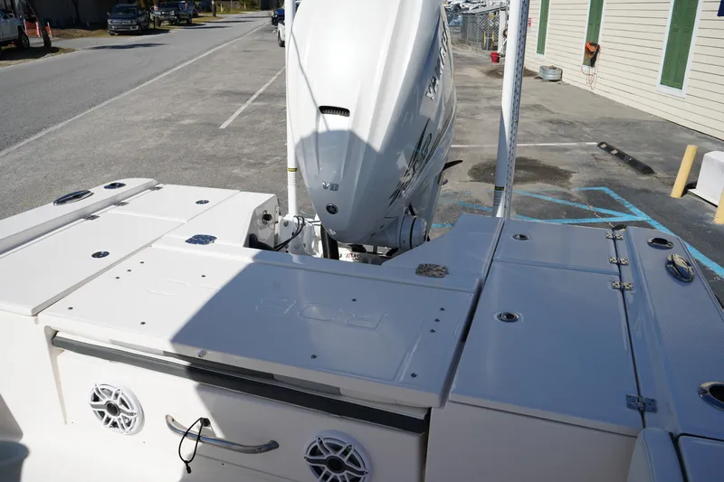 Slide: The Image of 2023 Robalo 266 Cayman boat with Yamaha outboard engine, docked in a parking area. - 8