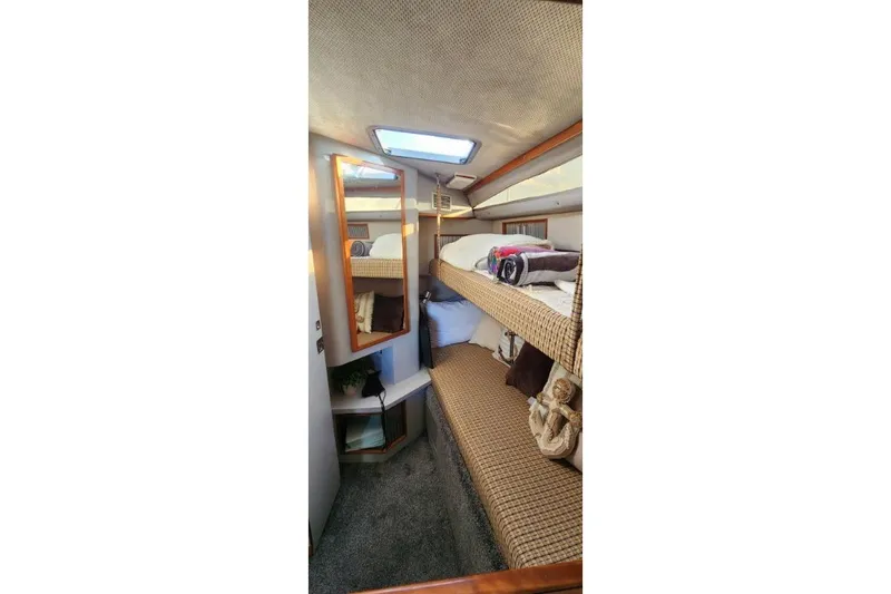 Slide: The Image of 1988 Sea Ray 390 Express Cruiser cabin with cozy bunk beds and nautical decor. - 26
