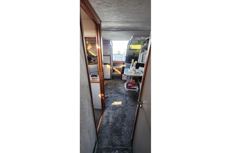 Slide: The Image of 1988 Sea Ray 390 Express Cruiser cabin with cozy bunk beds and skylight. - 27